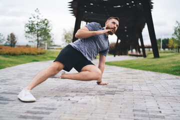 Focused sportsman doing side plank in park