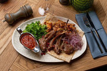 grilled pork ribs and grilled turkey meat on a plate in a restaurant