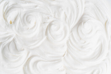 Creamy waves and swirls in yoghurt or cream surface. Top view.