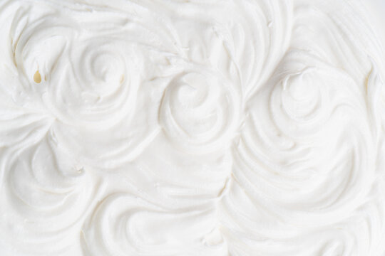 Creamy Waves And Swirls In Yoghurt Or Cream Surface. Top View.