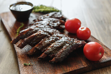 BBQ grilled pork ribs in Barbecue sauce on vintage wooden table background. Barbecue Pork Spare Ribs. Tasty snack to beer. American food concept. Selective focus - 538109302