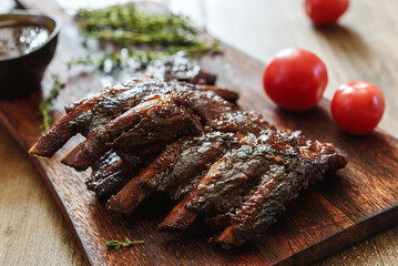 BBQ grilled pork ribs in Barbecue sauce on vintage wooden table background. Barbecue Pork Spare Ribs. Tasty snack to beer. American food concept. Selective focus - 538109307