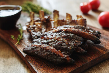 BBQ grilled pork ribs in Barbecue sauce on vintage wooden table background. Barbecue Pork Spare Ribs. Tasty snack to beer. American food concept. Selective focus - 538109343