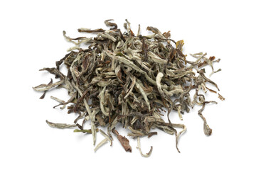 Heap of dried Nepalese white orange tea leaves close up isolated on white background