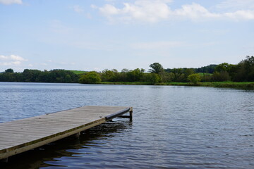 A short boat dock sits on a lake.
