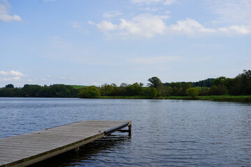A short boat dock sits on a lake.

