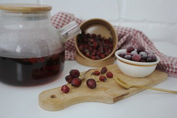 useful vitamin strong black tea in a transparent teapot. herbal tea in autumn