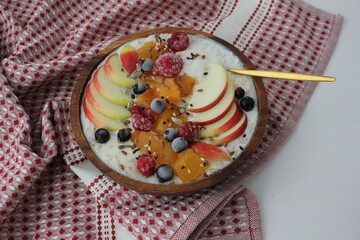 top view of delicious porridge with apple, pumpkin and berries