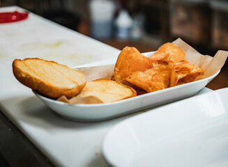 Delicious meal burger without meat with fries white plate in process. Healthy meat burger food on white kitchen table.