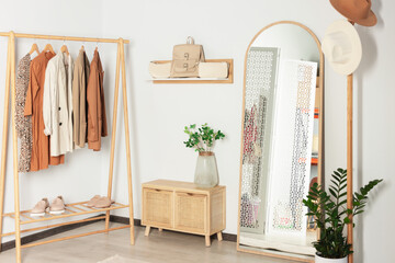 Modern hallway room interior with large mirror and clothing rack