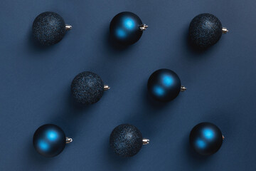 Christmas card with blue matte and glitter balls on dark blue background