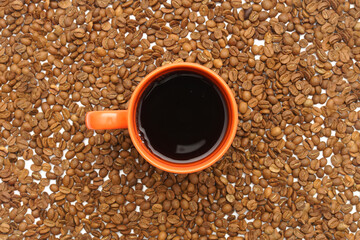 coffee beans on the floor, hot coffee in an orange mug