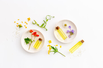 Medical herbs and flowers essential oil in bottles with plants