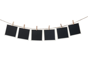 Clothespins with empty instant frames on string against white background. Space for text