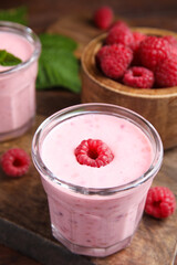 Tasty fresh raspberry smoothie on wooden table