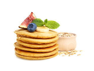 Tasty oatmeal pancakes and ingredients on white background