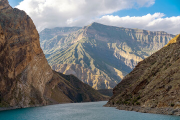 Scenic turquoise river among rocks and mountains. Confluence of Avar koysu and Andi koysu into...