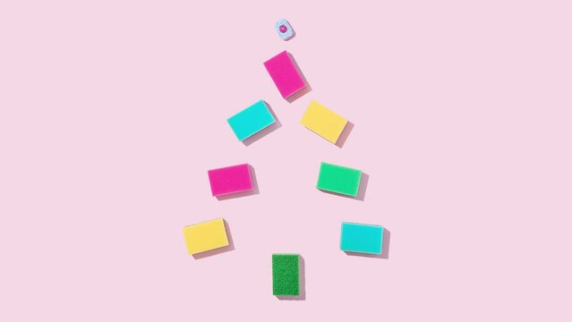 4K creative video. Minimal blinking Christmas tree made of colorful cleaning sponges and dishwasher tablet on bright pink background. New Year celebration trendy aesthetic. Winter holiday housework.