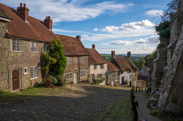 Fototapeta na wymiar A view of the picturesque Gold Hill in the town of Shaftesbury in Dorset, UK. The hill was made famous by being in the iconic Hovis advert.