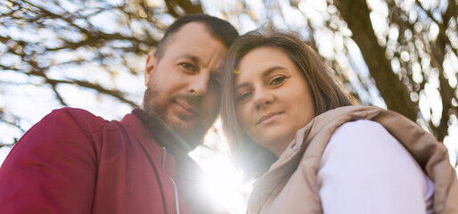 Fototapeta premium close-up portrait of a married couple in love husband and wife looking down at the camera