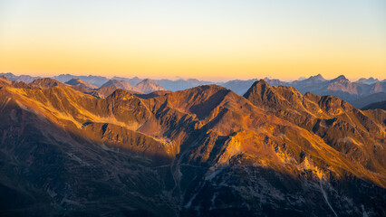 Alpine mountain peaks illuminated by rising sun