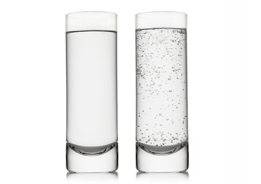 Mineral sparkling and still water in highball glass on white background.