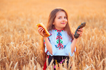 Bulgarian girl, beautiful woman, eating freshly baked banitsa, cheese pie during harvest In golden...