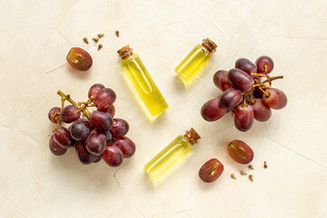Grape seed oil in bottles with bunch of grapes. Eco cosmetic product