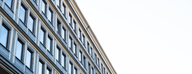 Facade of a building of some departments of the marshal's office in Katowice, Silesia, Poland. Socialist realist architecture from 1955. Rows of windows. - obrazy, fototapety, plakaty