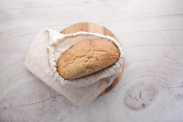 baked bread stored in a reusable linen bag . Eco friendly Zero waste concept..