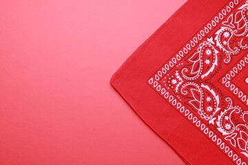Folded bandana with paisley pattern on red background, top view. Space for text