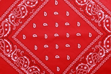 Top view of red bandana with paisley pattern as background