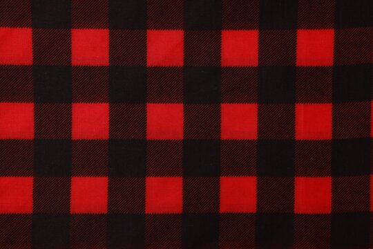 Top view of red bandana with check pattern as background
