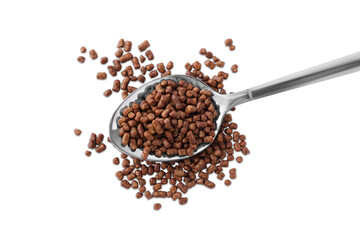 Spoon with buckwheat tea granules on white background, top view