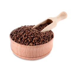 Wooden bowl with scoop and buckwheat tea granules on white background
