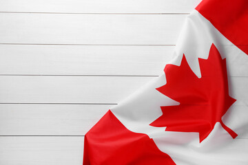 Flag of Canada on white wooden table, top view. Space for text