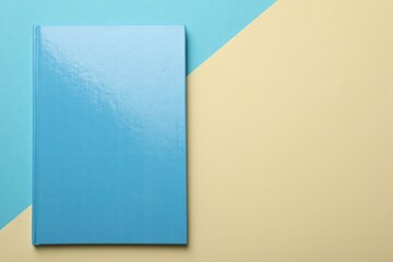 New light blue planner on color background, top view. Space for text