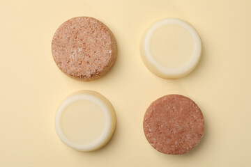 Flat lay composition with group of solid shampoo bars on beige background. Hair care