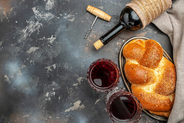 Shabbat Shalom challah bread, shabbat wine on a dark background, place for text, top view