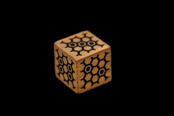 wooden dice on black background