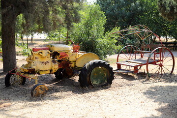Old agricultural machinery stands on the street in Israel and rusts