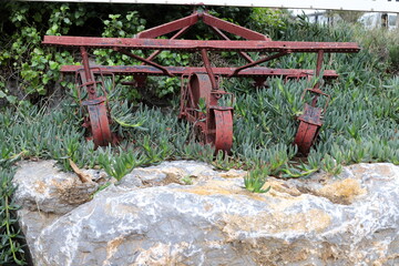 Old agricultural machinery stands on the street in Israel and rusts