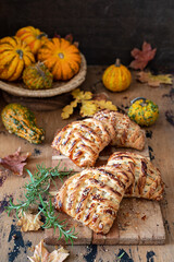 Puff pastries stuffed with pumpkin on a wooden table