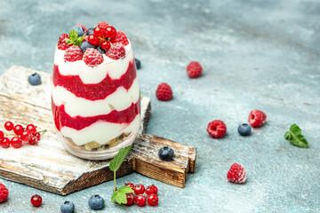 Cranachan raspberry dessert in jar on a lighr background. Long banner format
