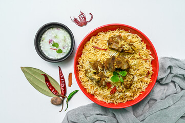 Delicious mutton biryani top view.Biryani rice dish Beautiful Indian rice dish.Delicious spicy chicken biryani in bowl over moody background, it’s a popular Indian and Pakistani food.