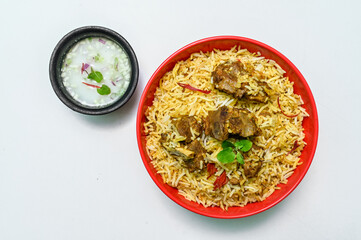 Delicious mutton biryani top view.Biryani rice dish Beautiful Indian rice dish.Delicious spicy chicken biryani in bowl over moody background, it’s a popular Indian and Pakistani food.