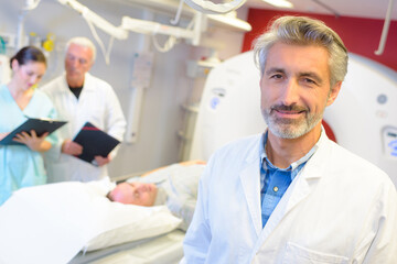 mri machine and screens with doctor and nurse