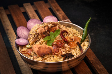 Delicious mutton biryani top view.Biryani rice dish Beautiful Indian rice dish.Delicious spicy chicken biryani in bowl over moody background, it’s a popular Indian and Pakistani food.