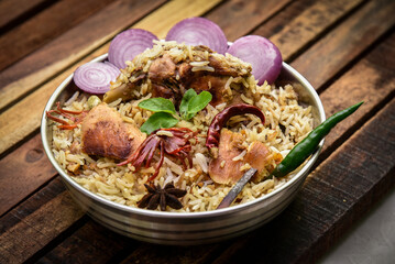 Delicious mutton biryani top view.Biryani rice dish Beautiful Indian rice dish.Delicious spicy chicken biryani in bowl over moody background, it’s a popular Indian and Pakistani food.