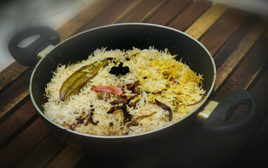 Delicious mutton biryani top view.Biryani rice dish Beautiful Indian rice dish.Delicious spicy chicken biryani in bowl over moody background, it’s a popular Indian and Pakistani food.